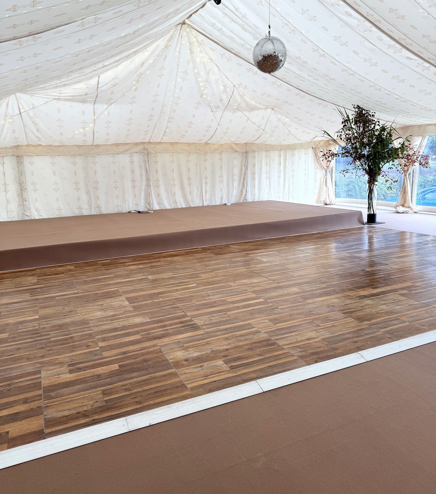 Interlocking vintage pine dance floor and stage setup